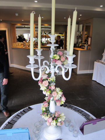 Candelabra display wrapped with Roses, Freesia and Wax Flower. Floral design by Cotswold Blooms, wedding florist based in Cheltenham.