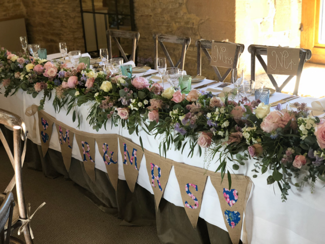 Full top table display including Peonies, Phlox, Roses, Astilbe and mixed Eucalyptus at Calcot Manor. Floral design by Cotswold Blooms, wedding florist based in Cheltenham.