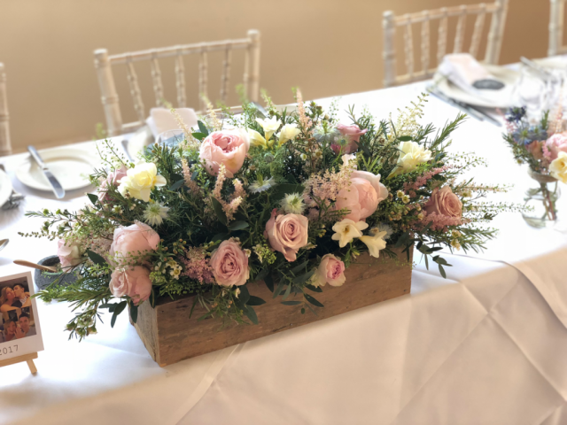 Rustic box filled soft pink Roses, Peonies and Wax Flower.  Floral design by Cotswold Blooms, wedding florist based in Cheltenham.