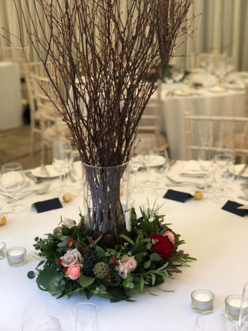 Mixed foliage ring with flower and berry detail and a twig display at Birtsmorton Court. Floral design by Cotswold Blooms, wedding florist based in Cheltenham.