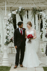 Red Rose bouquet and matching buttonhole at Manor by the Lake, Cheltenham. Floral design by Cotswold Blooms, wedding florist based in Cheltenham.