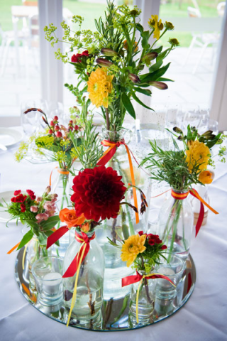 Scattered bottle table centre design. Floral design by Cotswold Blooms, wedding florist based in Cheltenham.