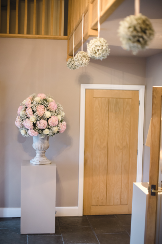 Entrance hall displays with hanging Gypsophila balls. Floral design by Cotswold Blooms, wedding florist based in Cheltenham.