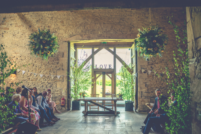 Flower balls at Cripps Stone Barn, in natural style with sunflowers and delphinium. Floral design by Cotswold Blooms, wedding florist based in Cheltenham.