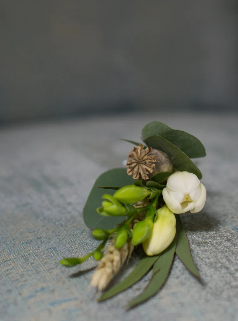 Freesia, poppy head and mixed eucalyptus buttonhole