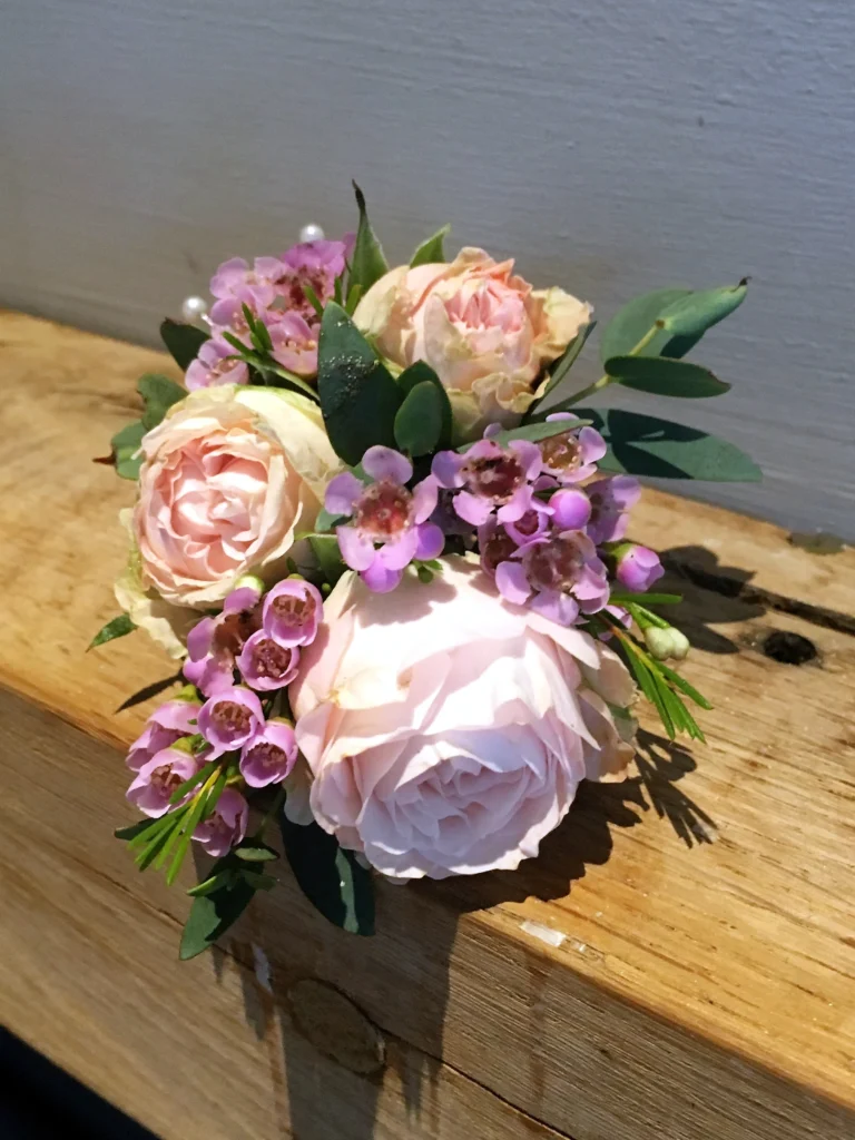 Light pink spray rose with waxflower foliage