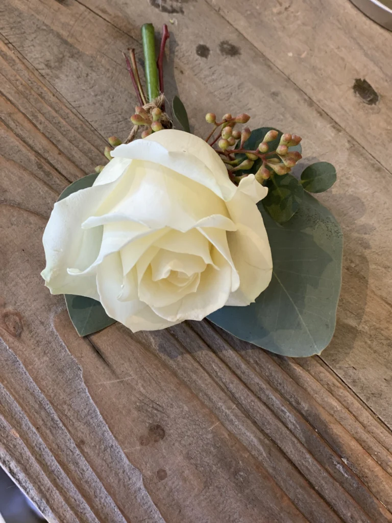 Classic white rose buttonhole with berry detail