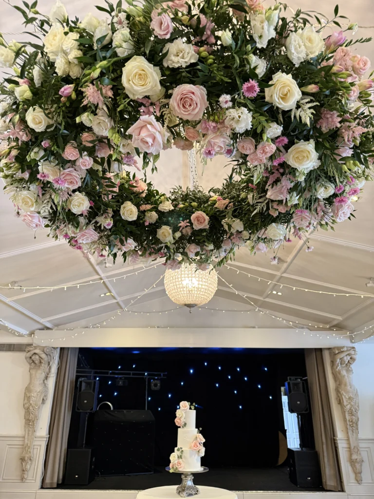 Halo floral installation with coordinating cake flowers at Manor by the Lake, Cheltenham