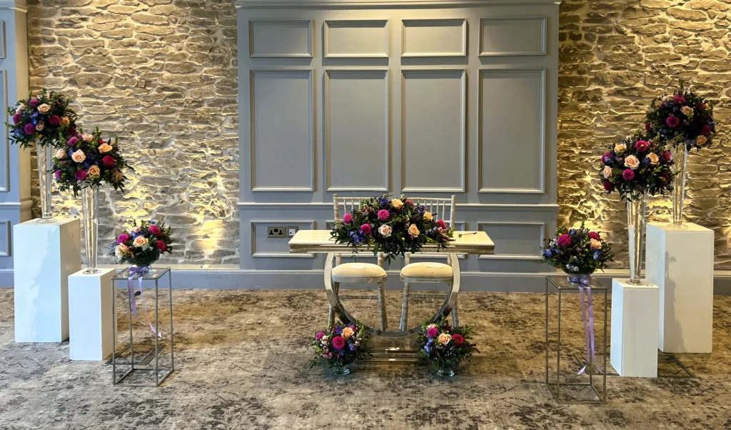 Using table centrepieces to dress the front of the wedding ceremony for maximum visual impact within a set budget