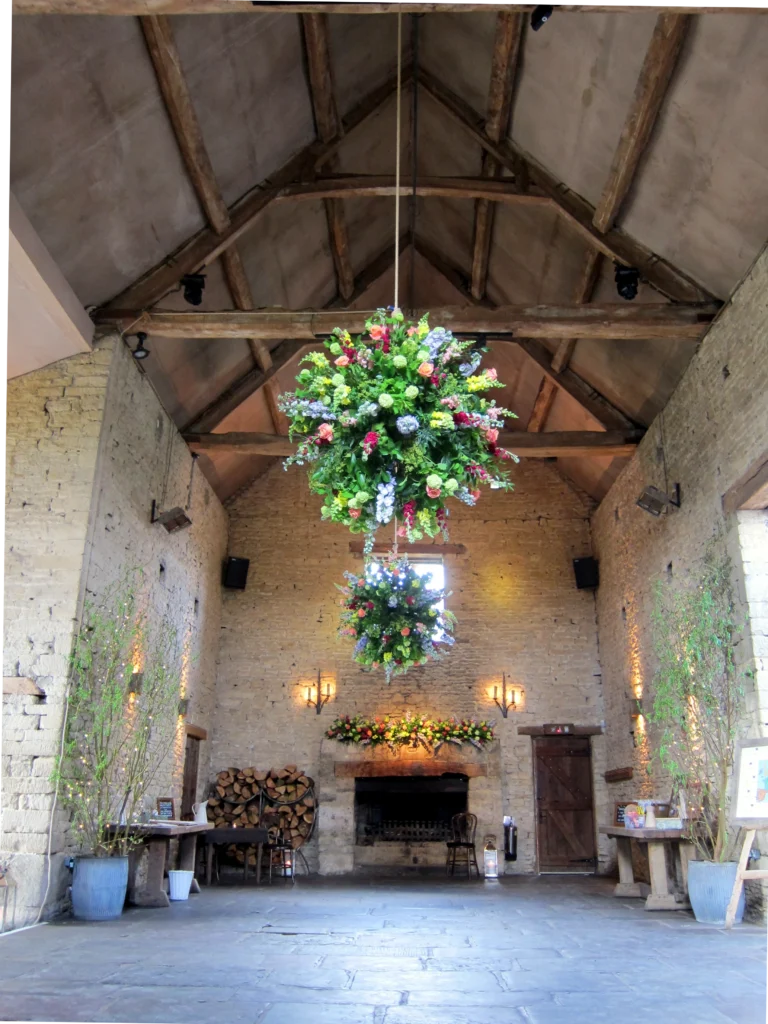 Cripps Stone Barn wedding styling featuring bright and vibrant flower balls