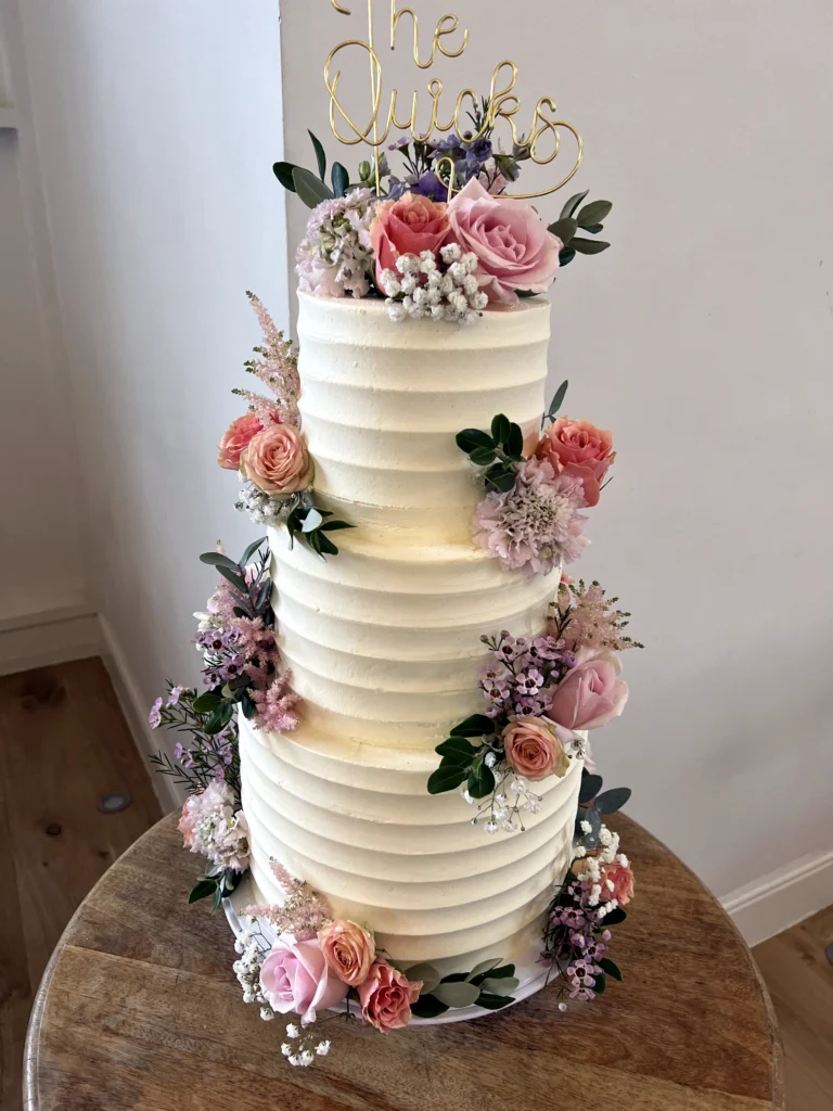 Wedding cake with fresh country garden flowers