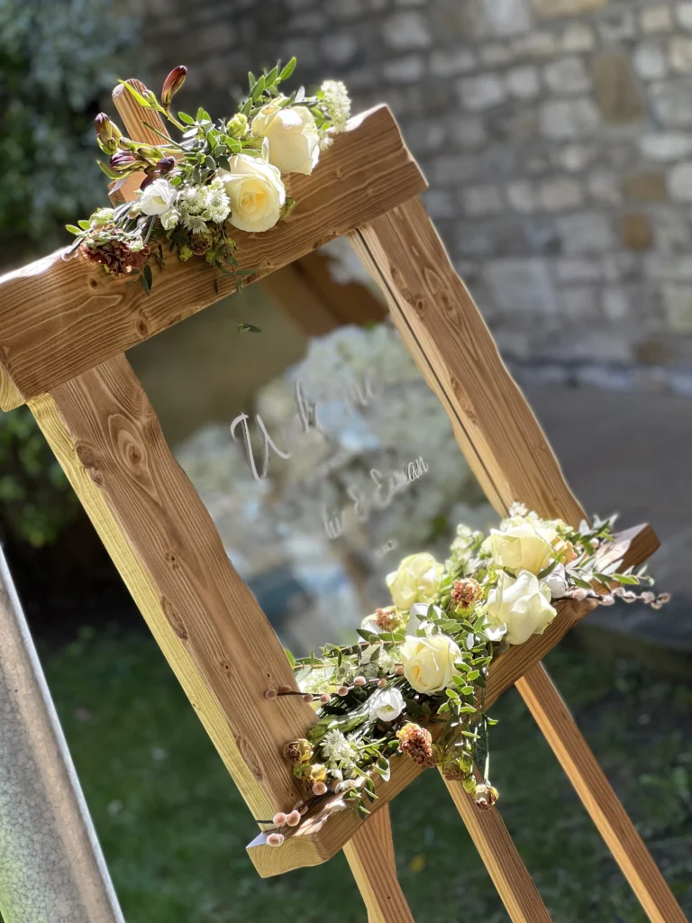 Floral welcome mirror arrangement featuring roses and lisianthus