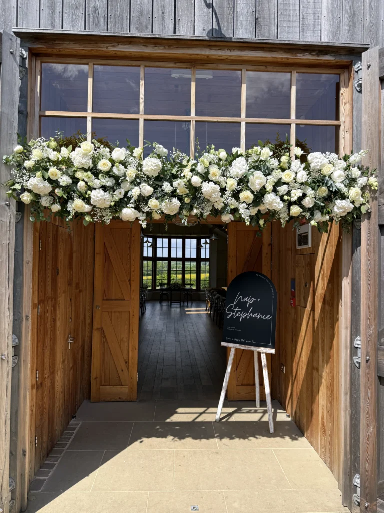 Classic white wedding flowers above The Grange, Hyde House, Stow-on-the-Wold