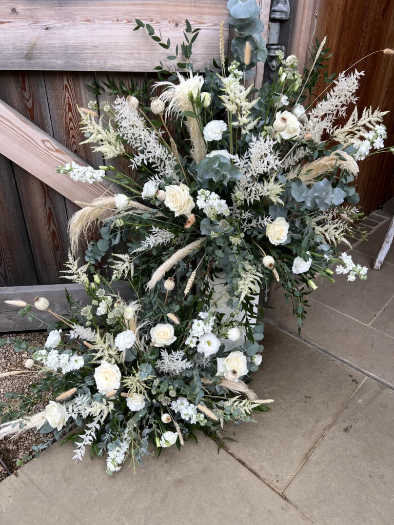 Textural welcome arrangements with dried ruscus, pampas grass and poppy heads