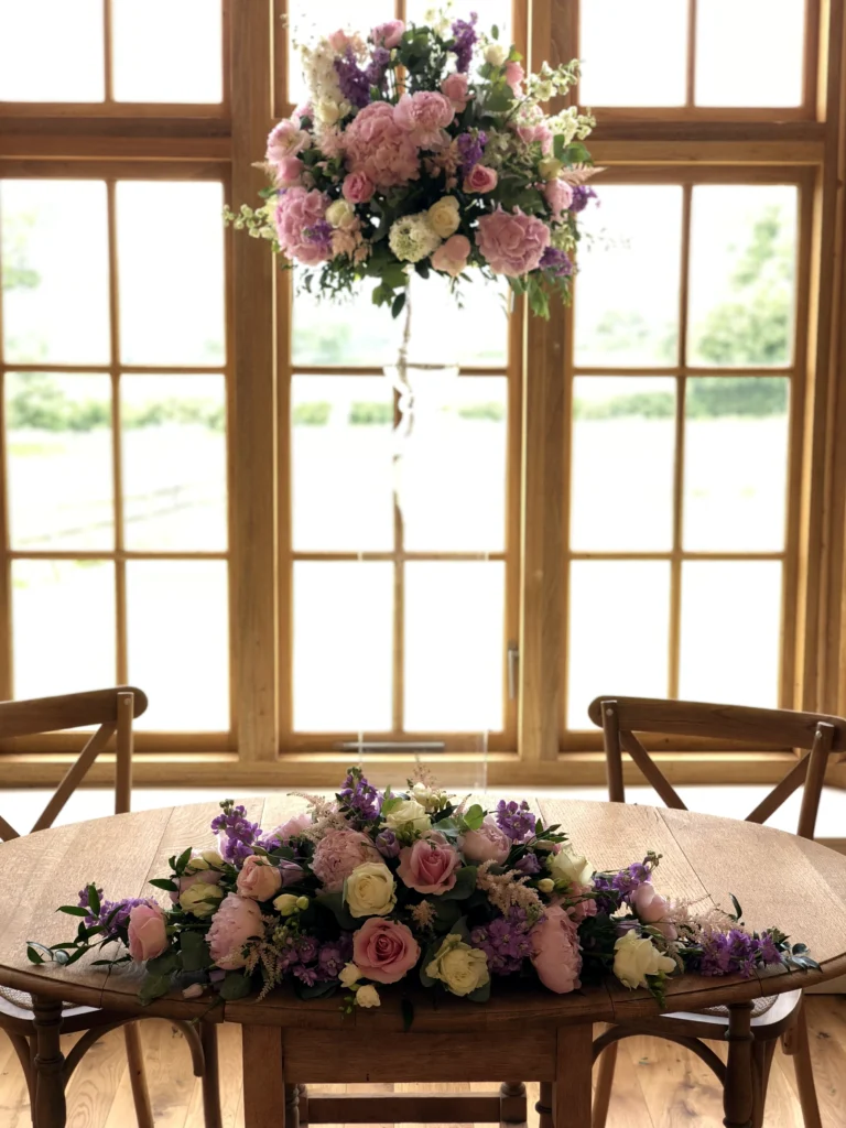Peonies, roses and stocks for matching ceremony tables and pedestal display