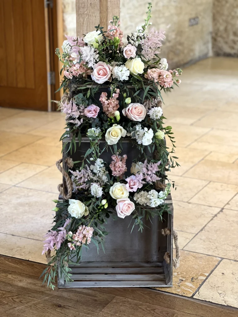 Three floral arrangements on stacked crates