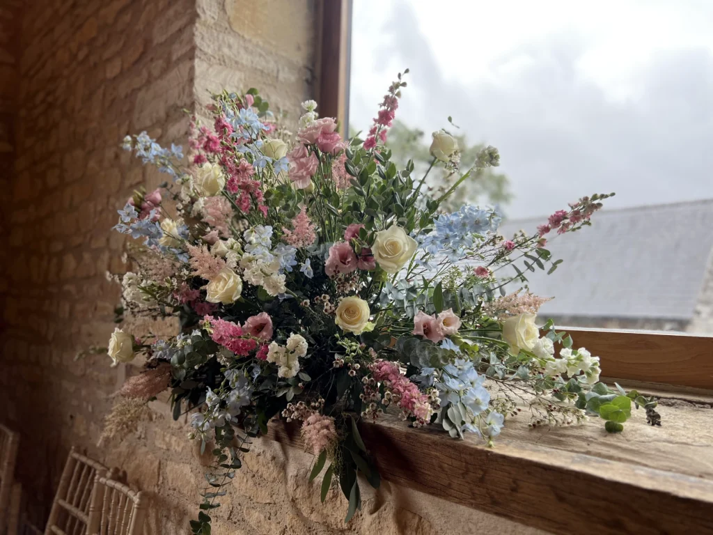Barn at Upcote window display with pretty cottage garden flowers