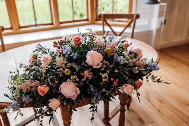 Wildflower long and low display for top table and ceremony at Hyde House