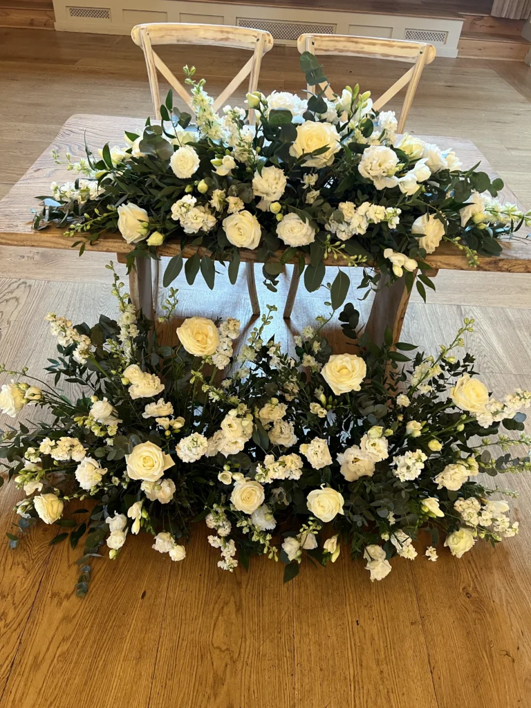 Classic sweetheart table styled with white wedding flowers