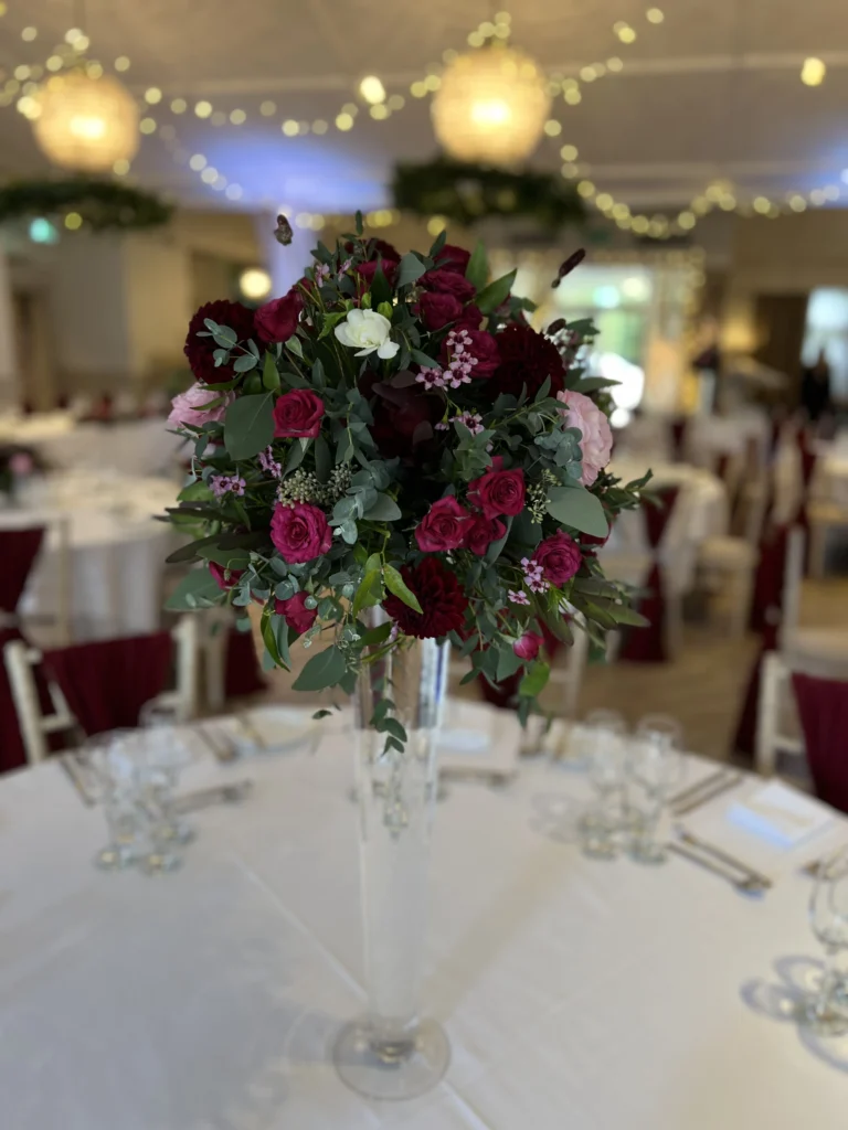 Tall table centrepiece in rich tones at Manor by the Lake, Cheltenham