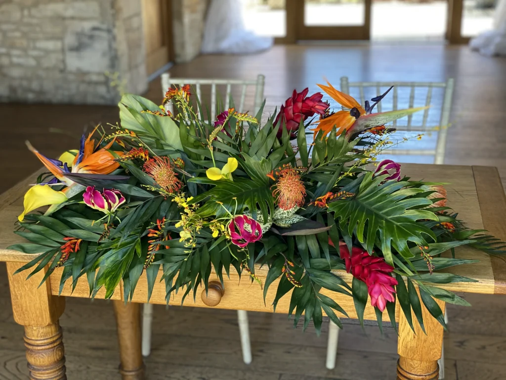 Bold tropical table styling with bird of paradise and ginger at Barn at Upcote