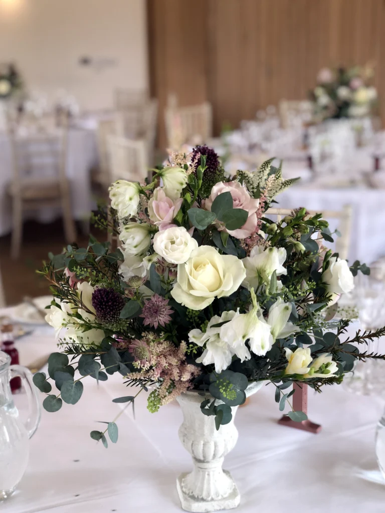 Wedding table mini urn display with textured styling at Hyde House