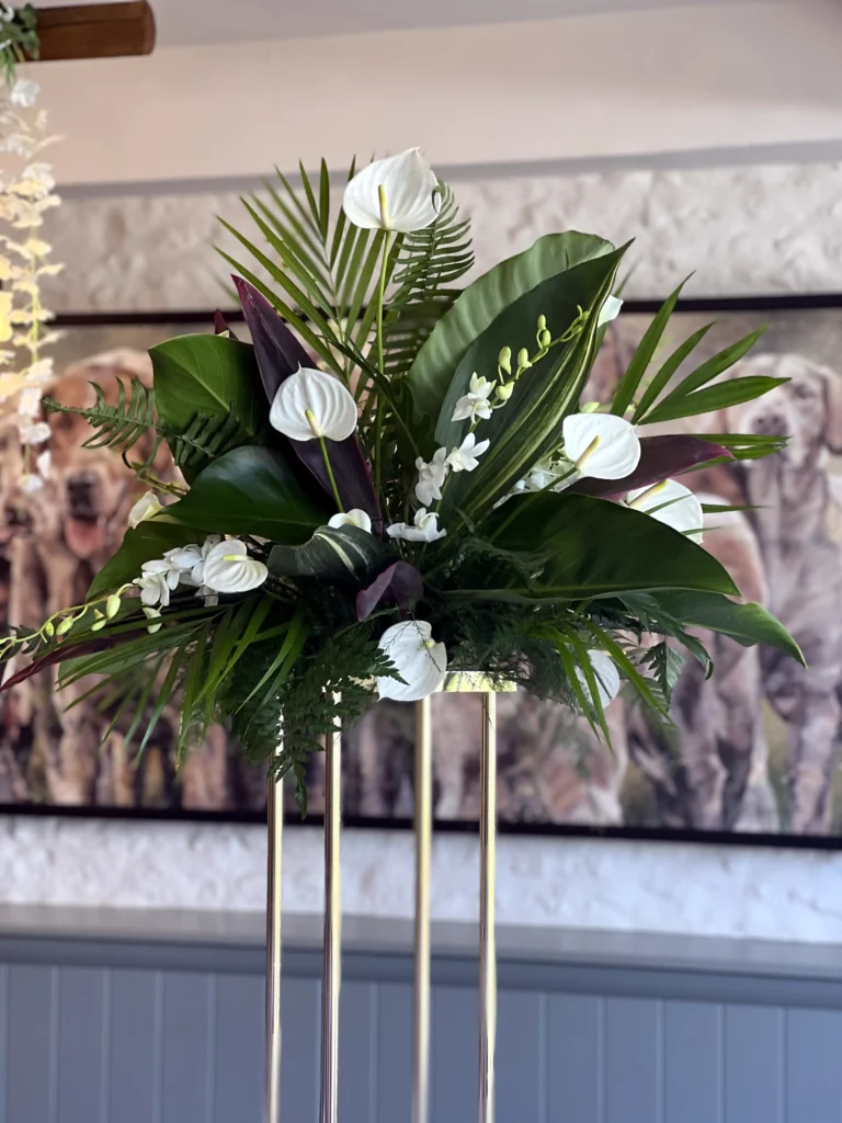 Statement raised tropical floral centrepiece with orchids and anthuriums