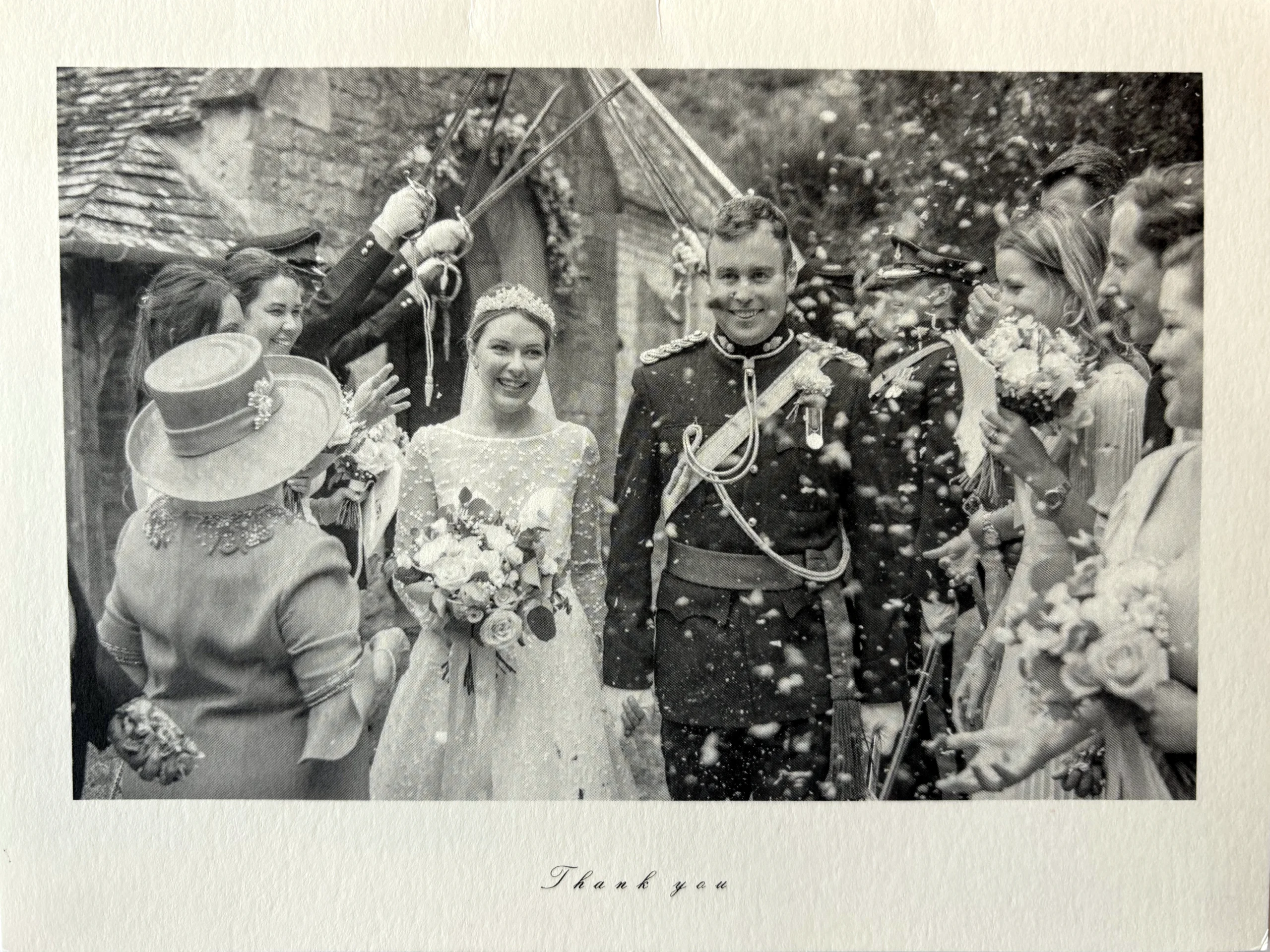 Church arch and wedding bouquet photograph taken while confetti is being thrown