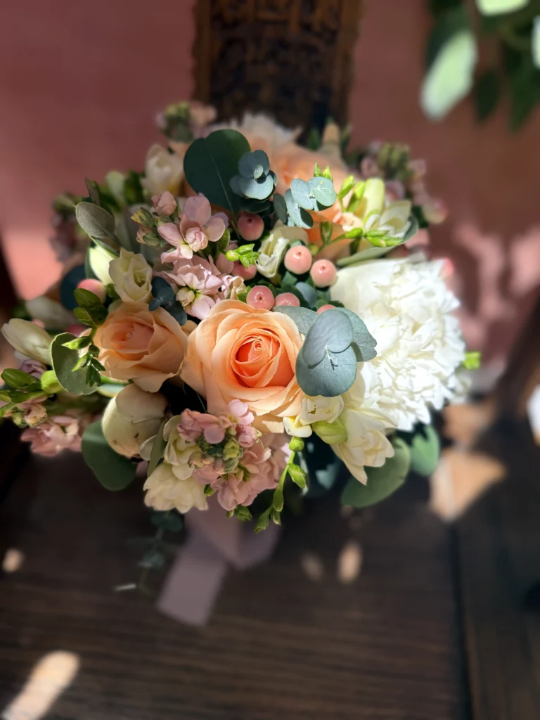 Peach roses with white peonies for a summer wedding at Matara Weddings