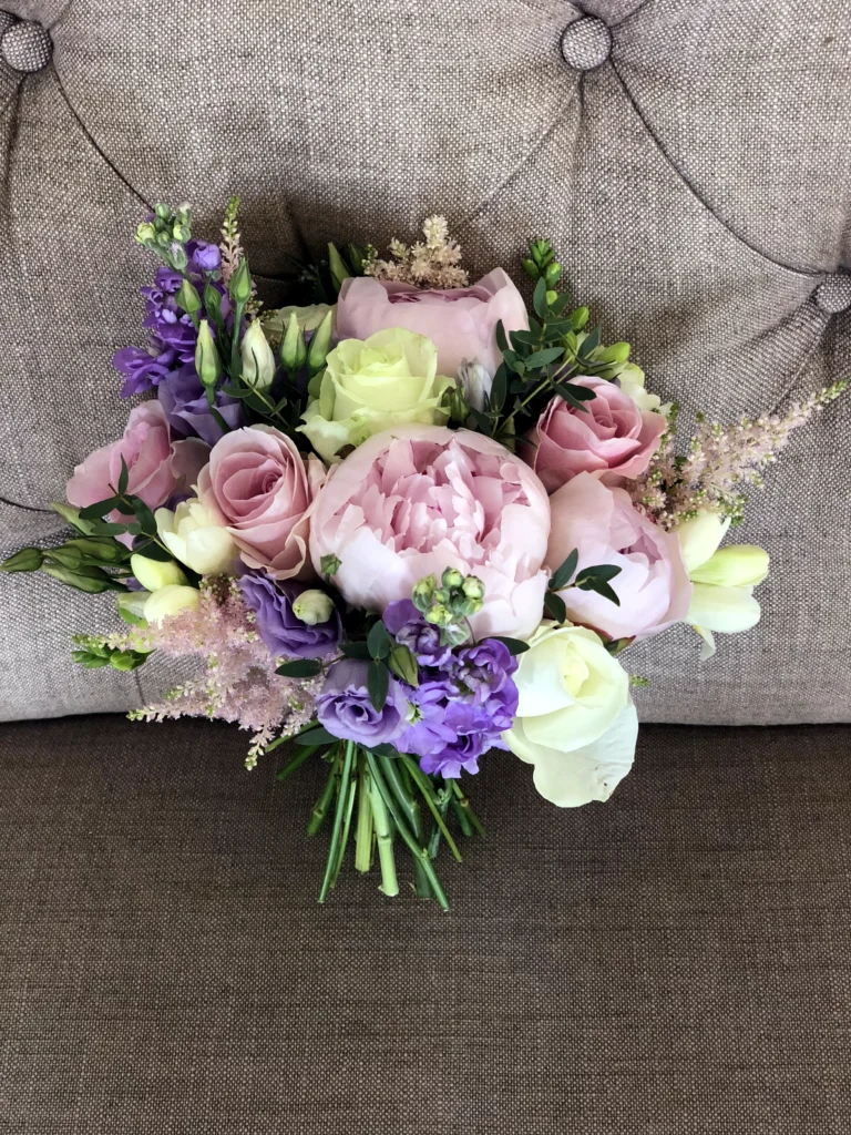 Hand tied bouquet in pastel shades including Roses, Peonies, Stocks and Freesia