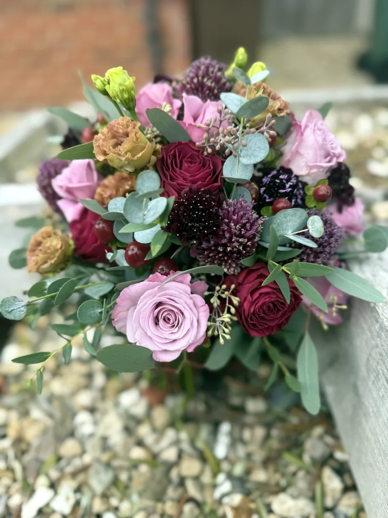 Rich burgundy and purple tones making this luxury bridal bouquet