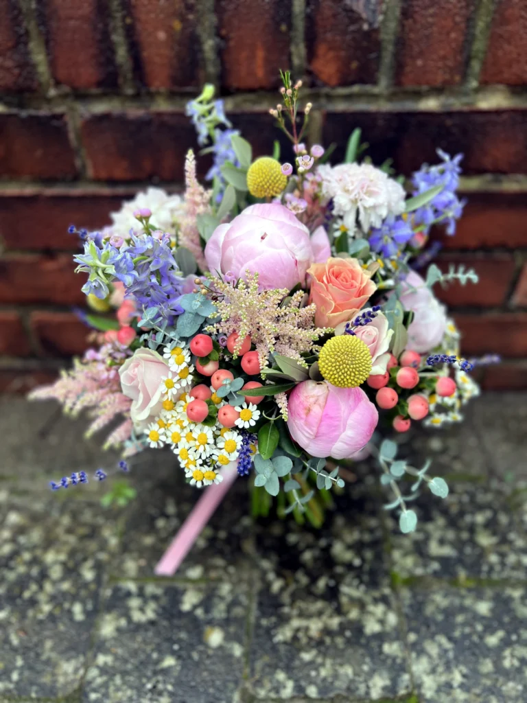 Country garden summer bouquet with peonies and pops of colour