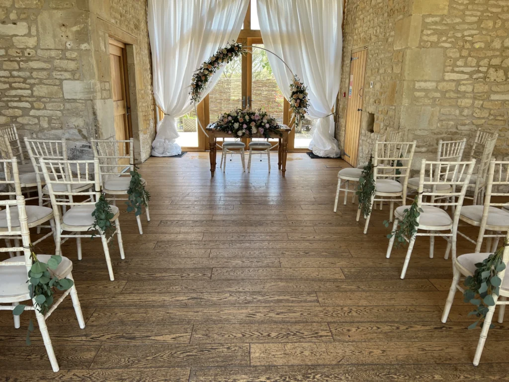 Barn at Upcote ceremony floral installation Cotswolds wedding florist