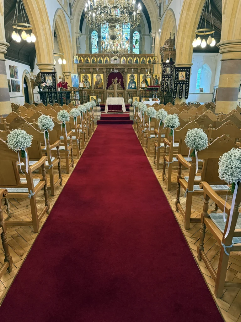 Gypsophila aisle markers lining the aisle in a Greek Orthodox church