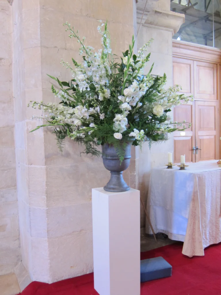 Statement pedestal arrangement with ferns, gladioli and roses for church wedding