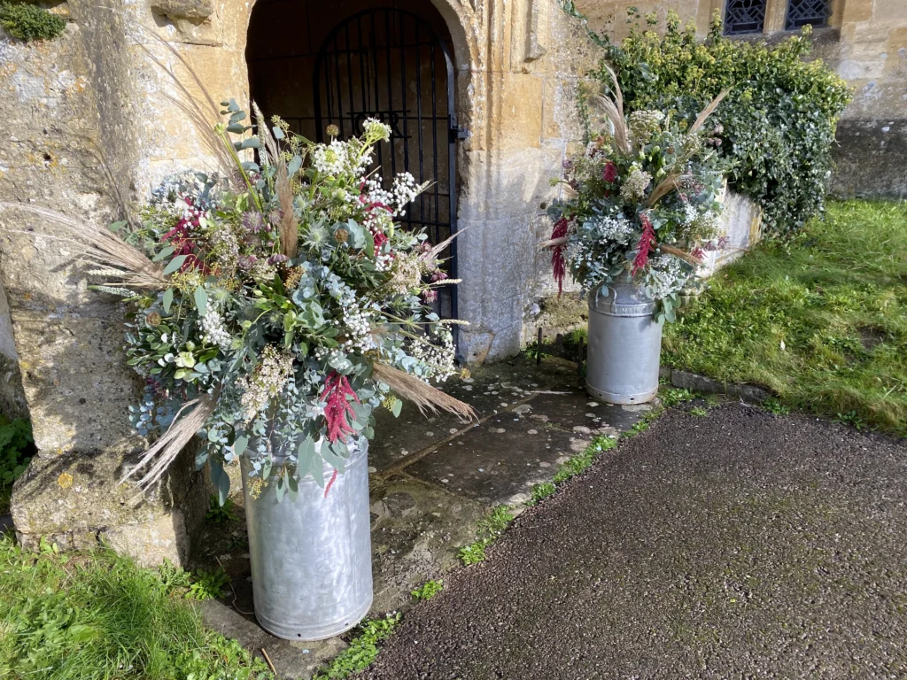 Wild-style milk churn displays with pampas grass and natural textures
