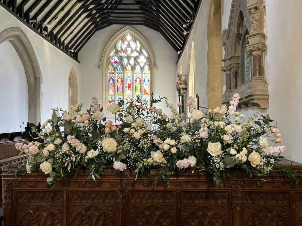 Organic front-of-church floral display in a relaxed natural style