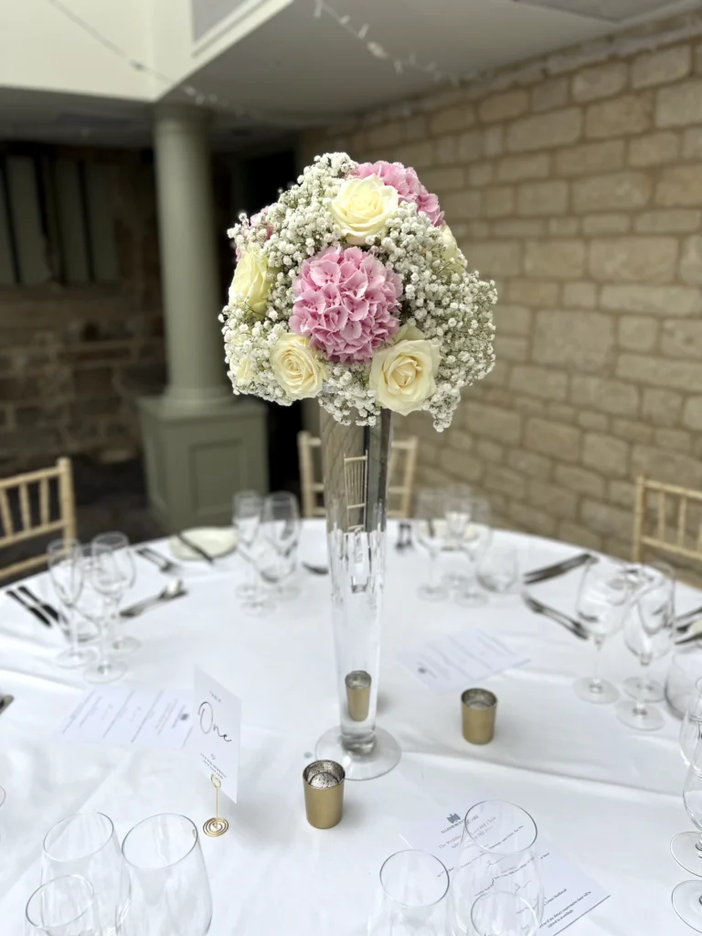 Ellenborough Park 19 Cotswold Blooms is a luxury wedding florist in Cheltenham and the Cotswolds, creating refined, bespoke floral designs using seasonal British flowers. Table centrepiece wedding flowers Ellenborough Park Cheltenham