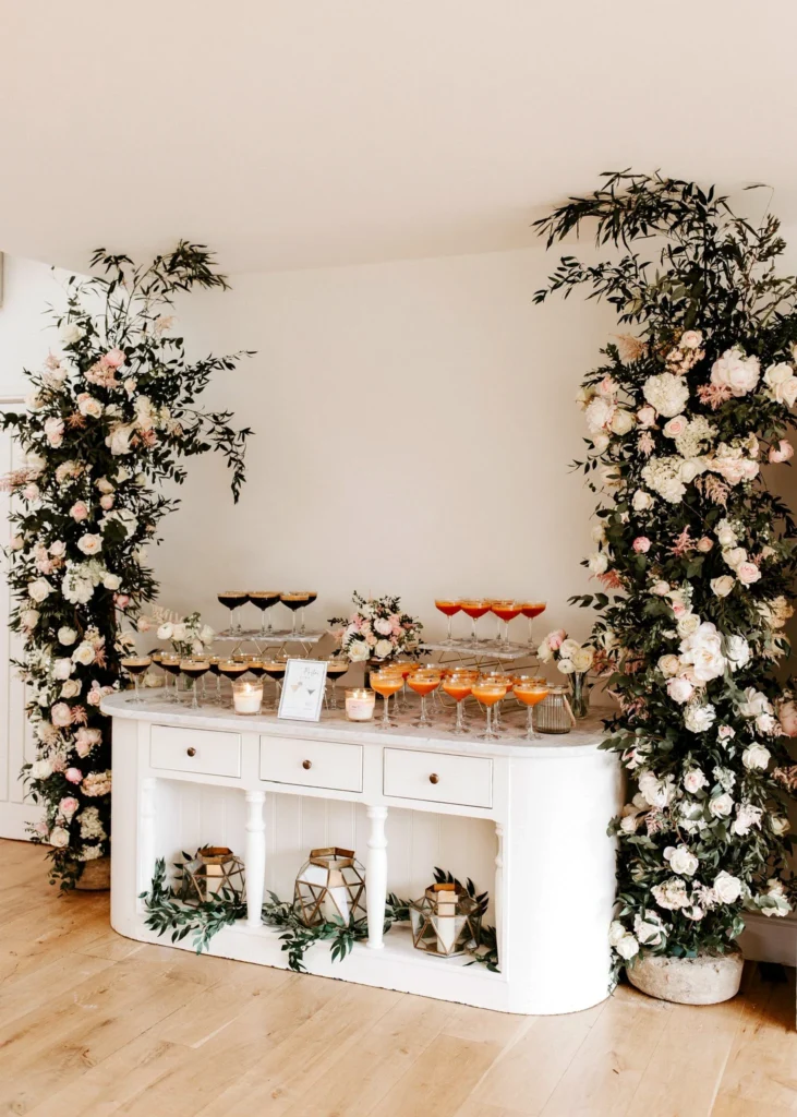Cocktail hour bar styling with a broken floral arch