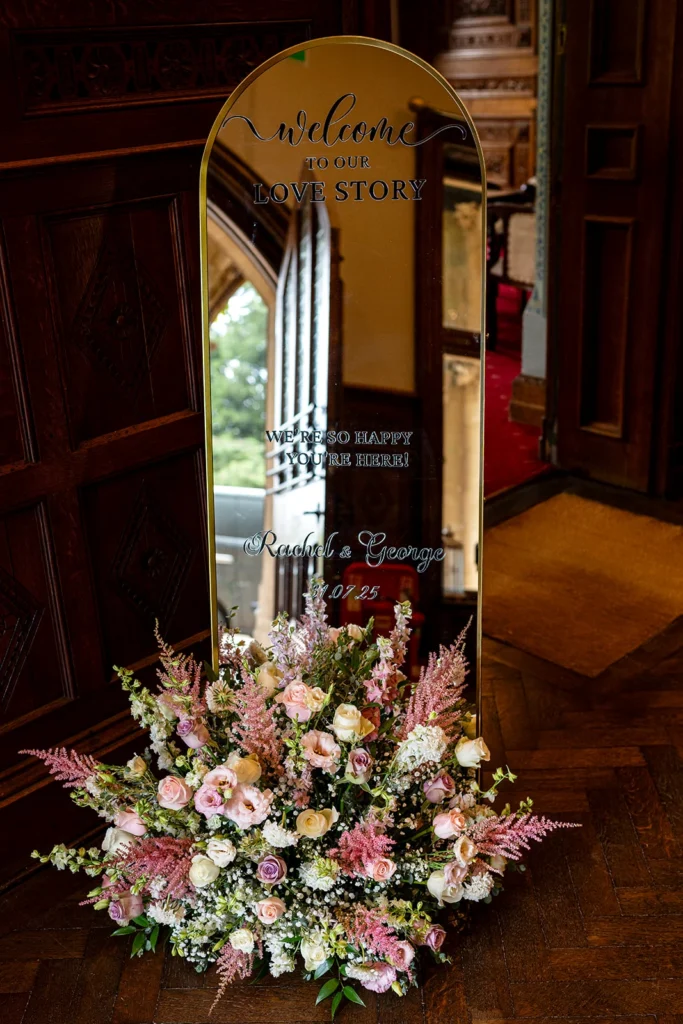 Welcome mirror with meadow floral display in pastel shades, at Manor by the Lake, Cheltenham
