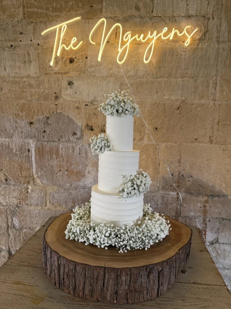 Cake wedding flowers at Lapstone Barn by Cotswold Blooms