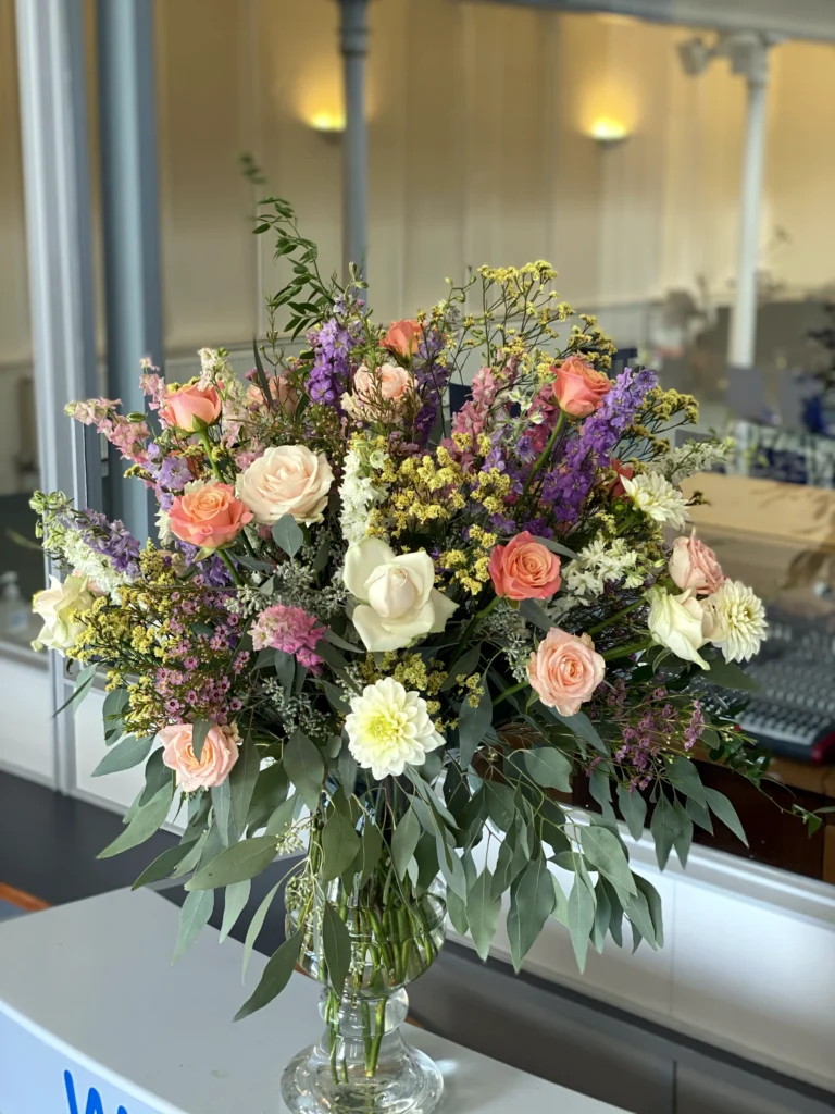 Church vase display with vibrant textured florals