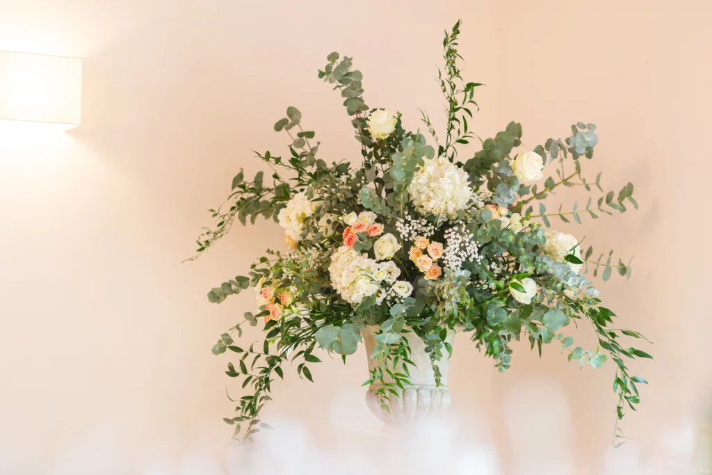 Bohemian rustic stone urn display with trailing eucalyptus