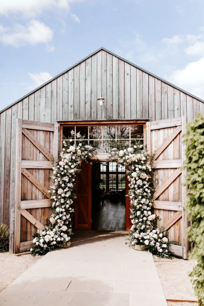 Grand entrance arch display with roses and hydrangeas at The Grange, Hyde House