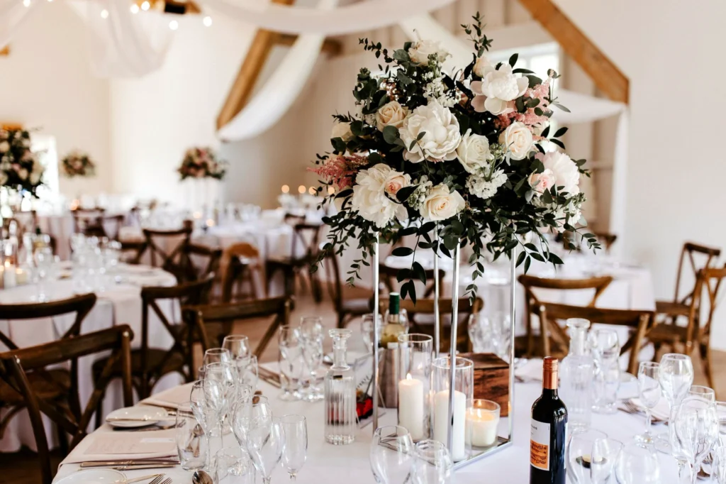 Elevated table floral display with candles and seasonal flowers