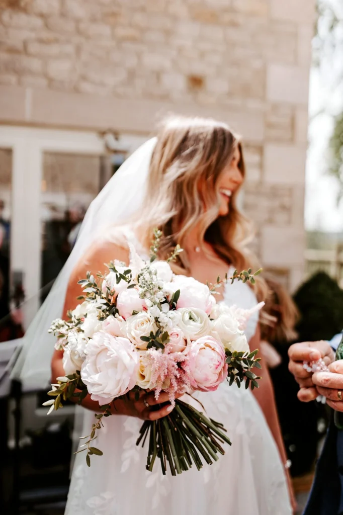 White and blush pink bridal bouquet featuring peonies and roses
