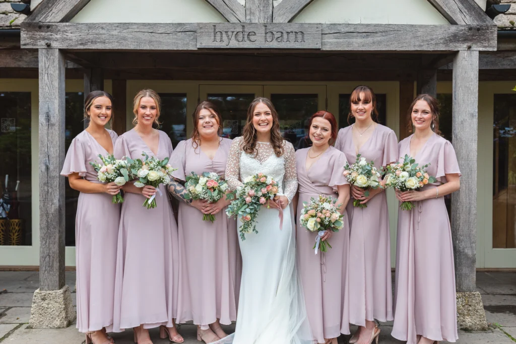 Trailing cascading bridal bouquet with hand-tied bridesmaid bouquet for a Cotswolds wedding