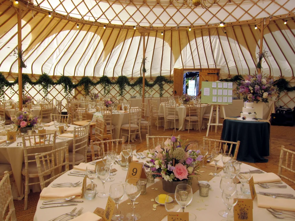Floral entrance arch with roses, peonies and eucalyptus for a Cotswold marquee wedding