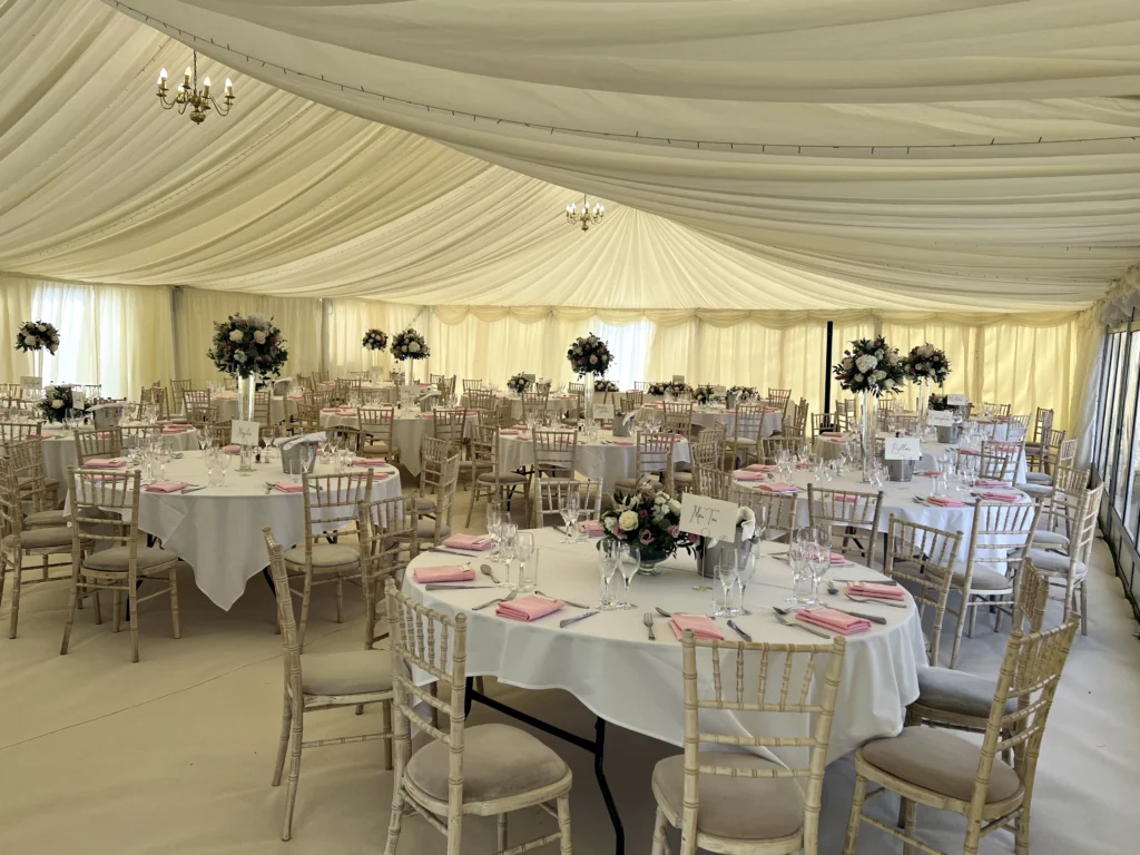 Bowl centrepiece and lily vase with roses and eustoma for a country garden marquee wedding