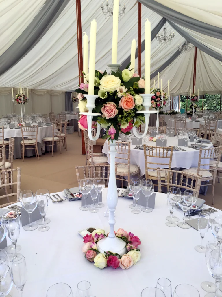 Rose and seasonal flower candelabra centrepiece for a marquee wedding in the Cotswolds